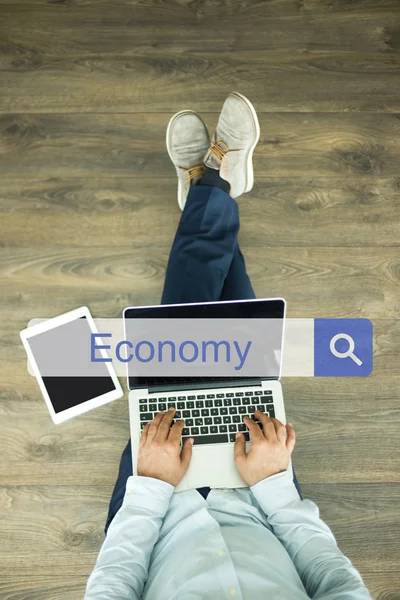 Young man sitting on floor with laptop — Stock Photo, Image