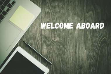  WELCOME ABOARD  text on desk  clipart