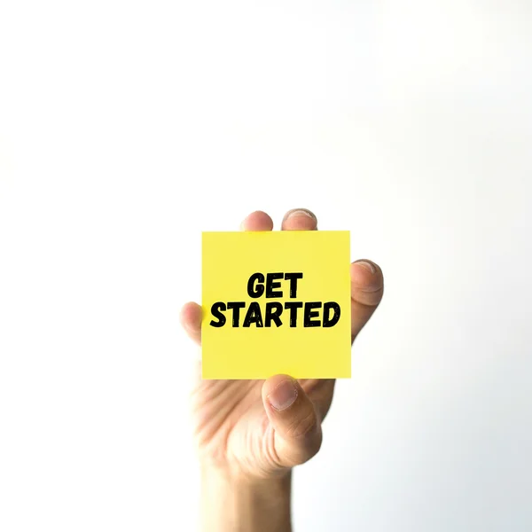 Hand holding yellow sticky note — Stock Photo, Image