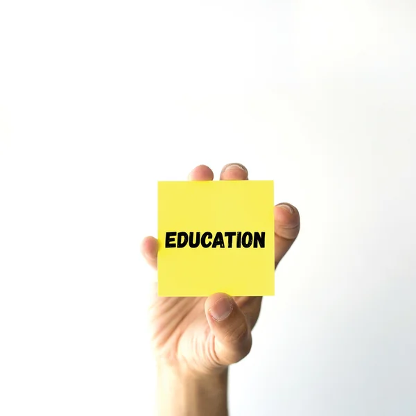 Hand holding yellow sticky note — Stock Photo, Image