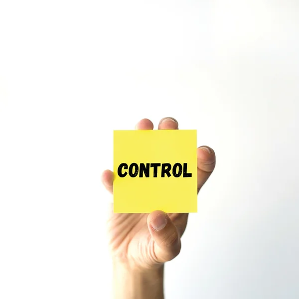 Hand holding yellow sticky note — Stock Photo, Image