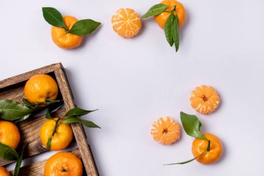 Tahta tepside taze taze mandalinalar Açık Mavi Arkaplan Üst Görünümü ile