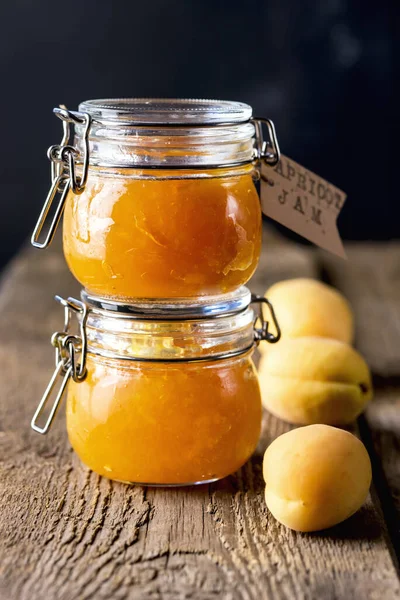 Homemade Apricot Jam in Jars and Fresh Fruits Apricot Old Wooden Background Dark Photo Vertical