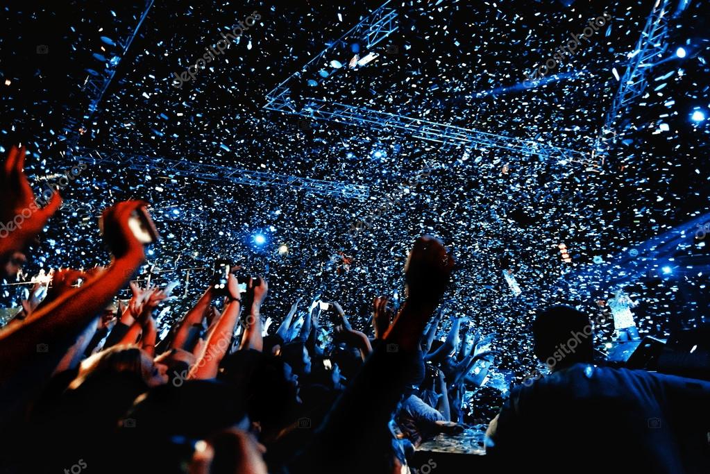 Night club party event concert with crowd of people and confetti at the