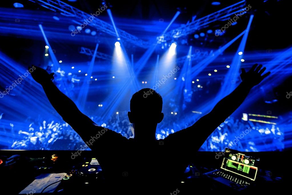 Dj at night club party event concert with crowd of people at the stage Stock Photo by ©glazok90