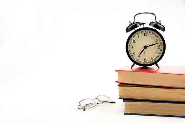 Tree books with alarm clock on white — Stock Photo, Image