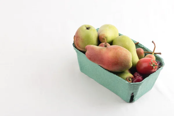 Fresh juicy pears in a carton box on white background — Stock Photo, Image