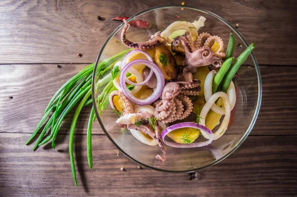 Έτοιμο φρέσκα καλαμάρι και πλοκάμια ενός χταποδιού με πατάτες κατσαρόλας και πράσινων λαχανικών σε ρουστίκ — Φωτογραφία Αρχείου