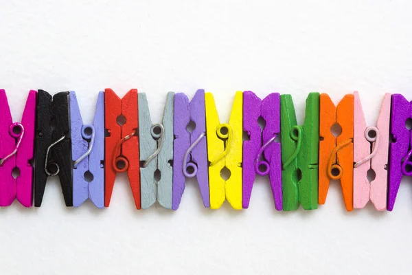 Colored wooden clothespins on a light background — Stock Photo, Image