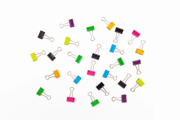 Pinzas de encuadernación coloridas sobre un fondo blanco — Foto de Stock