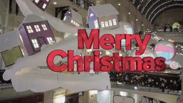 在一个有圣诞装饰背景的购物中心中央，用3D字母写着圣诞快乐 — 图库视频影像