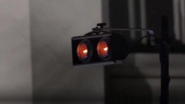 Sahnede iki parlak spot ışığı yanıp sönüyor, sonra flaşlı ışıkların arka planında, parlak bir döngü halinde.