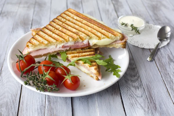 Sandwich frais savoureux avec jambon au fromage et pain grillé isolé sur fond de bois — Photo