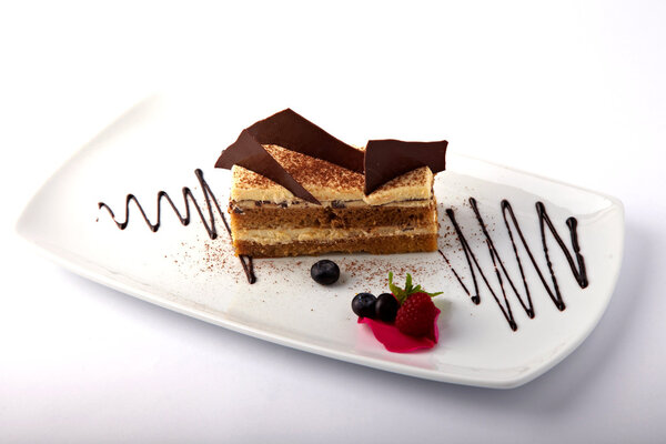 Cake with custard and summer berries on a white background