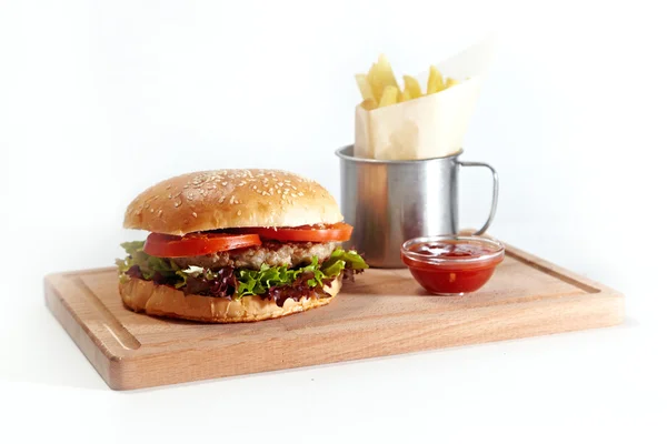 Hamburger and french fries in a mug on white background — Stock Photo, Image