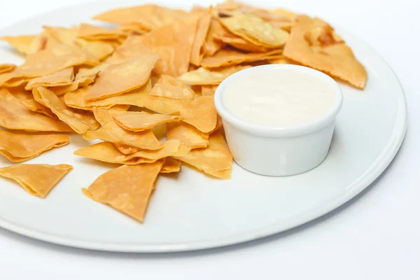 Homemade pita chips made from pita bread with olive oil on white background
