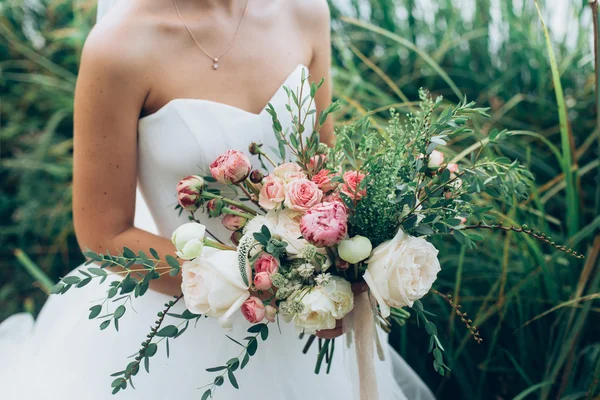 Noiva segurando buquê de casamento — Fotografia de Stock