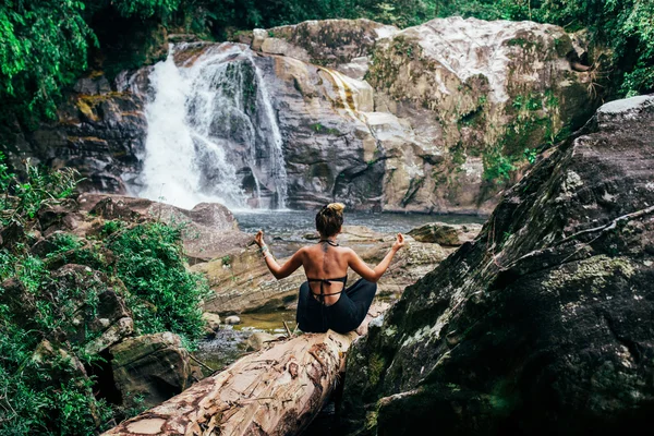 La chica medita en las cataratas — Foto de Stock