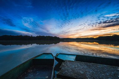 Beautiful autumn sunrise by a rural pond.
