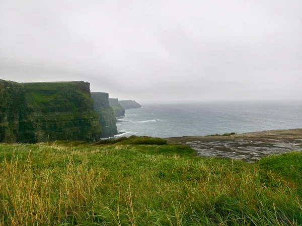 View of the Cliffs of Moher in summer. Cliff in Ireland, on the Atlantic Ocean in County Clare.