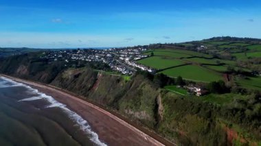 Holcombe, South Devon, England: DRONE VIEWS: The coastline, cliffs and railway track near houses on the eastern edge of the town of Teignmouth. Teignmouth is an active port and popular UK holiday destination (Clip 2 of 2).