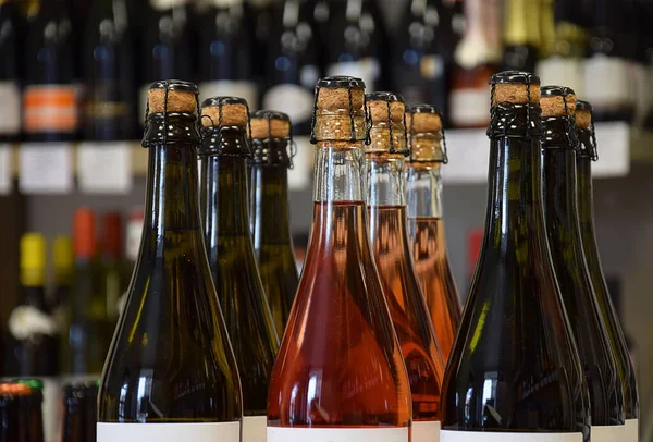 Lightly sparkling wine bottles in wine store and ready for home delivery