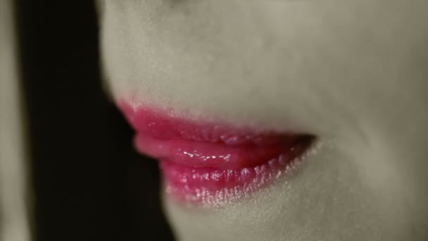 Los labios rojos. Concepto blanco y negro. La boca de la mujer muerde los labios. Sexy labios femeninos de cerca — Vídeo de stock