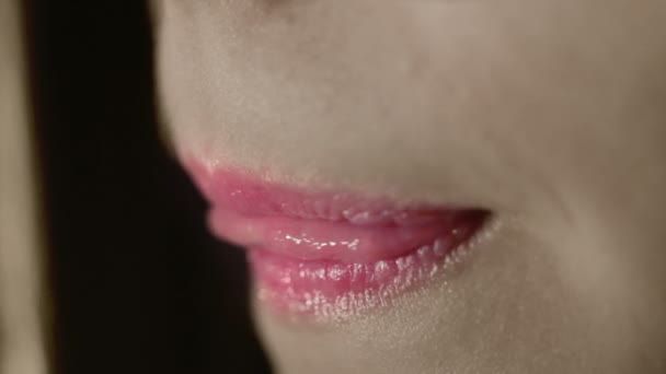 Pink lips of young woman. Pink lipstick on fashion model lips. Sensual woman mouth — Stock video