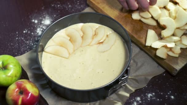 Chef puts apple pieces in baking pan. Baking apple pie. Man making dessert — Stock Video