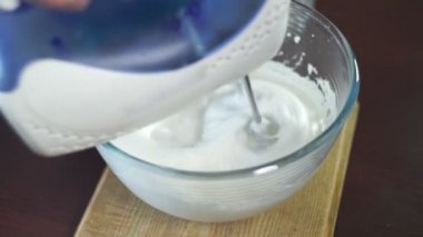 Whipping cream in mixing bowl. Making cream. Baking ingredients