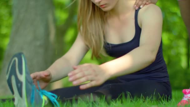 フィットの女の子が公園でストレッチします。否定的な感情を表現する金髪女性のクローズ アップ — ストック動画