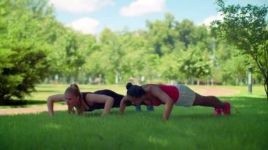 Young women rest after push ups exercise outdoor