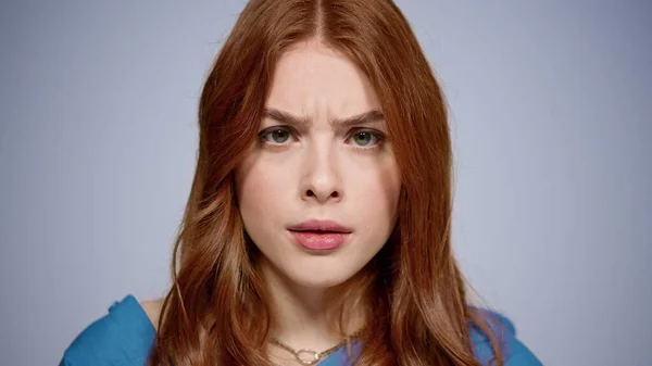 Gloomy girl looking at camera in studio. Disappointed woman posing indoors — Stock Photo, Image