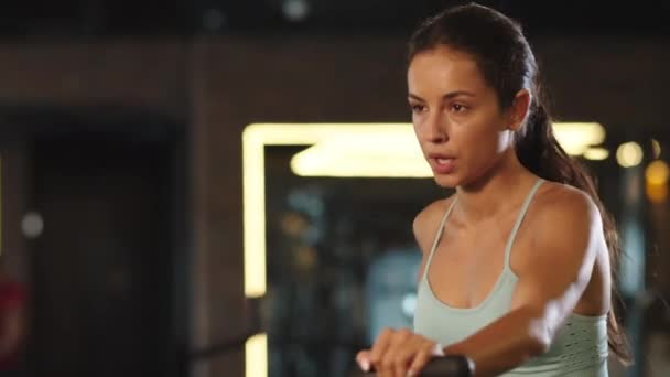 Entrenamiento de atleta femenina progresivo en el gimnasio. Ajuste chica usando exercycle en club — Vídeo de stock