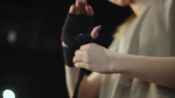 Unknown woman preparing for boxing in sport club. Closeup woman wrapping hands — Stock Video