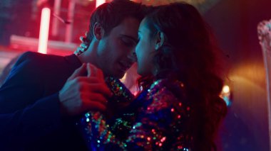 Bir çift gece kulübünde dans etmekten zevk alıyor. Erkek ve kadın partide sarılıyor.