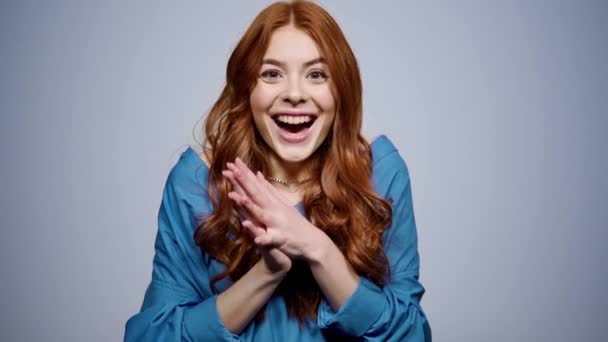 Positive girl making hand gestures in studio. Woman getting good news indoors — Stock Video