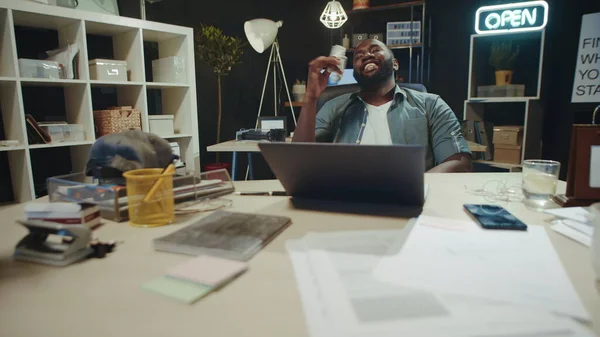 Handsome african american business man enjoying money smell in hipster office.