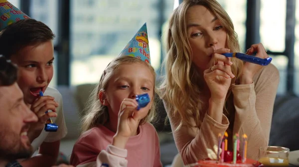 Mom dad kids celebrating birthday online. Happy family having fun party blowers. — Stock Photo, Image