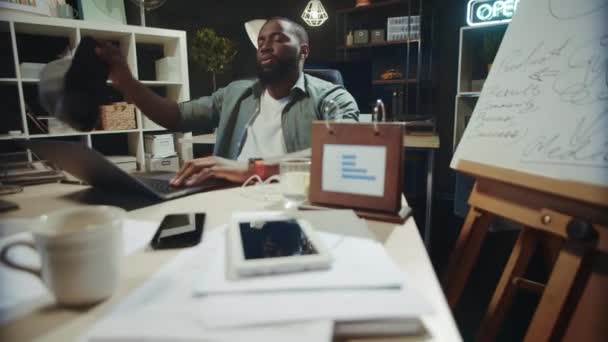 Exhausted african american businessman having relax in office chair indoors. — Stock Video