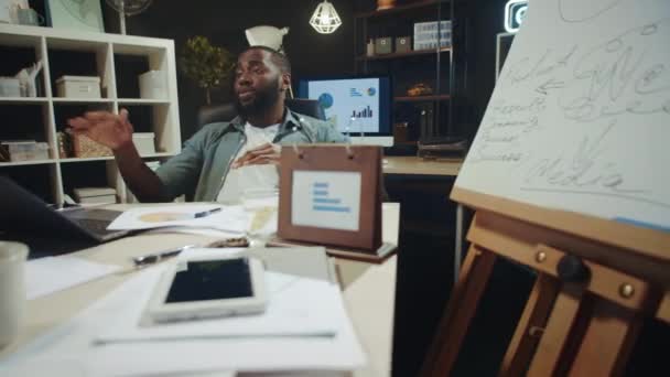 Portrait of african american manager having fun near laptop in hipster office. — Stock Video