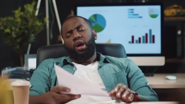 Κοντινό πλάνο εξαντληθεί afro επιχειρηματίας κοιτάζοντας τα χαρτιά στο γραφείο hipster. — Αρχείο Βίντεο
