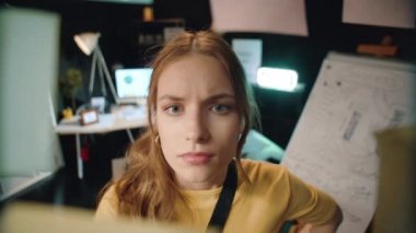 Odaklanmış kadın yönetici hipster ofisinde kargaşa tahtasıyla çalışıyor..