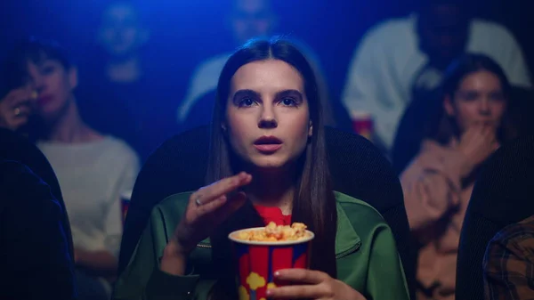 Mladá žena se dívá na zajímavý film v kině. Atraktivní dívka jíst popcorn — Stock fotografie