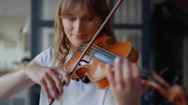 家庭でバイオリンを学ぶ女性。ロマンチックな女の子再生バイオリンとともに弓 — ストック動画