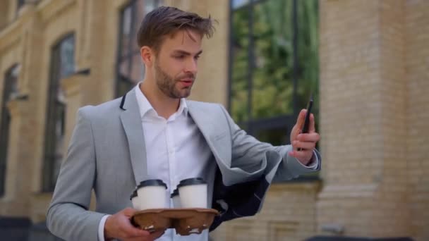 Mann nimmt Anruf Smartphone draußen. Geschäftsmann läuft auf der Straße zur Arbeit — Stockvideo