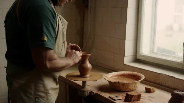 Ceramist making clay product in pottery. Senior man sculpting jar in workshop — Stock Video