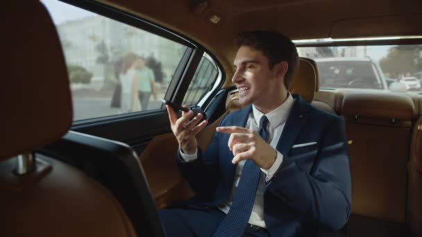 Rigoroso maschio professionale dando istruzioni nel messaggio vocale in auto moderna. — Video Stock