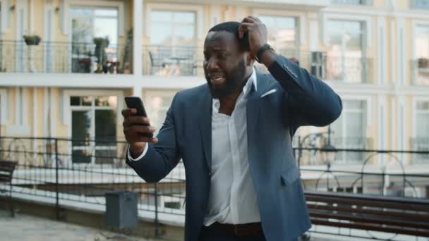 Upset afro business man getting bad news outdoors. Businessman feeling upset — Stock Video