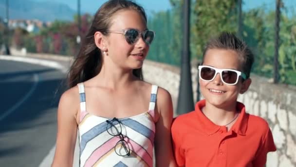 Usmívající se děti si užívají letní venku. Veselí teenageři mluví na ulici. — Stock video